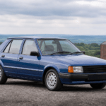 Blue first-generation Ford Orion at a British countryside viewpoint