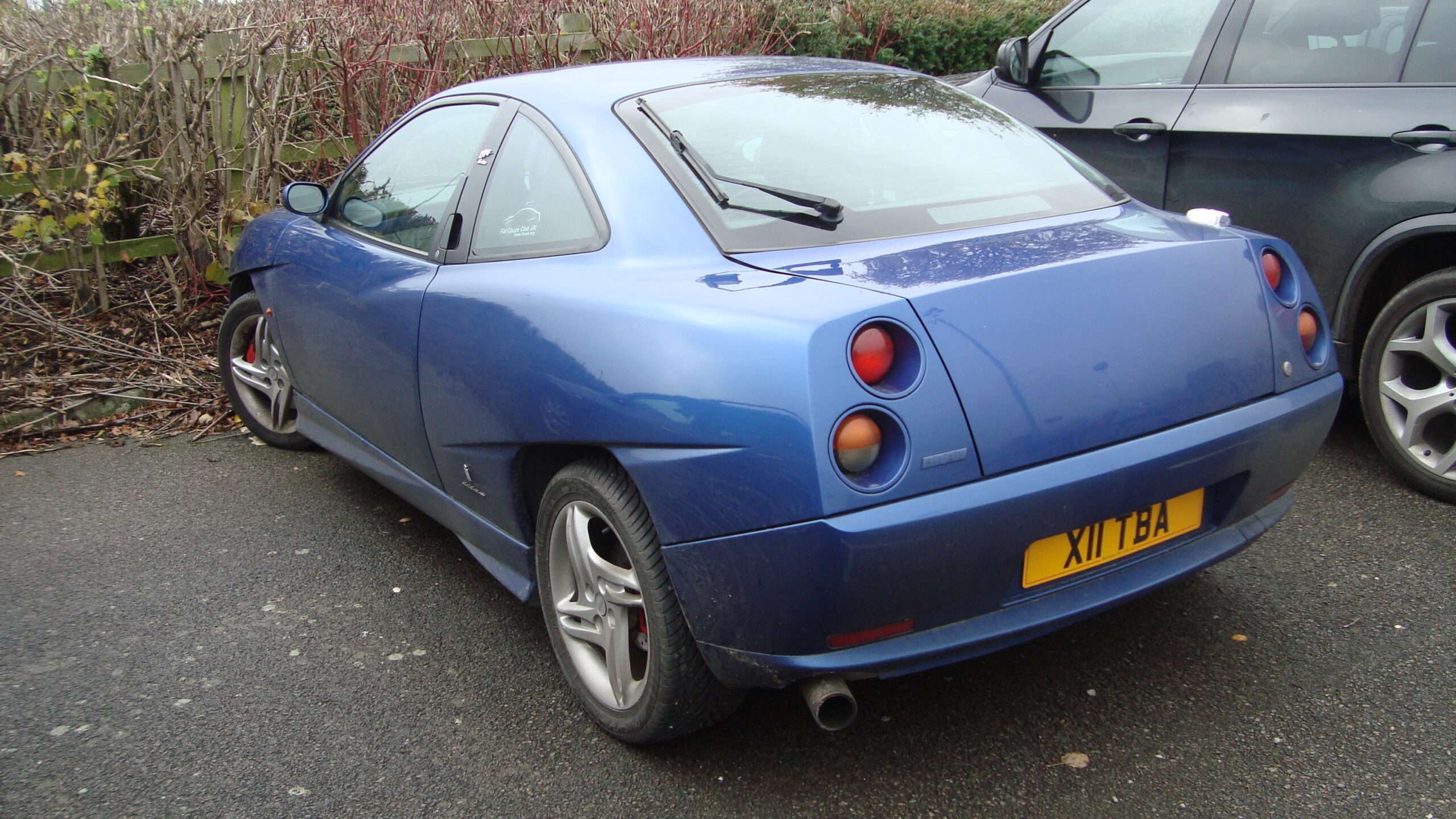Yellow 2000 Fiat Coupé 20V Turbo Plus viewed from the rear three-quarter angle