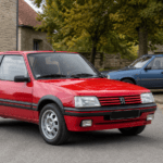 Red Peugeot 205 GTI with a five-door Peugeot 205 behind it