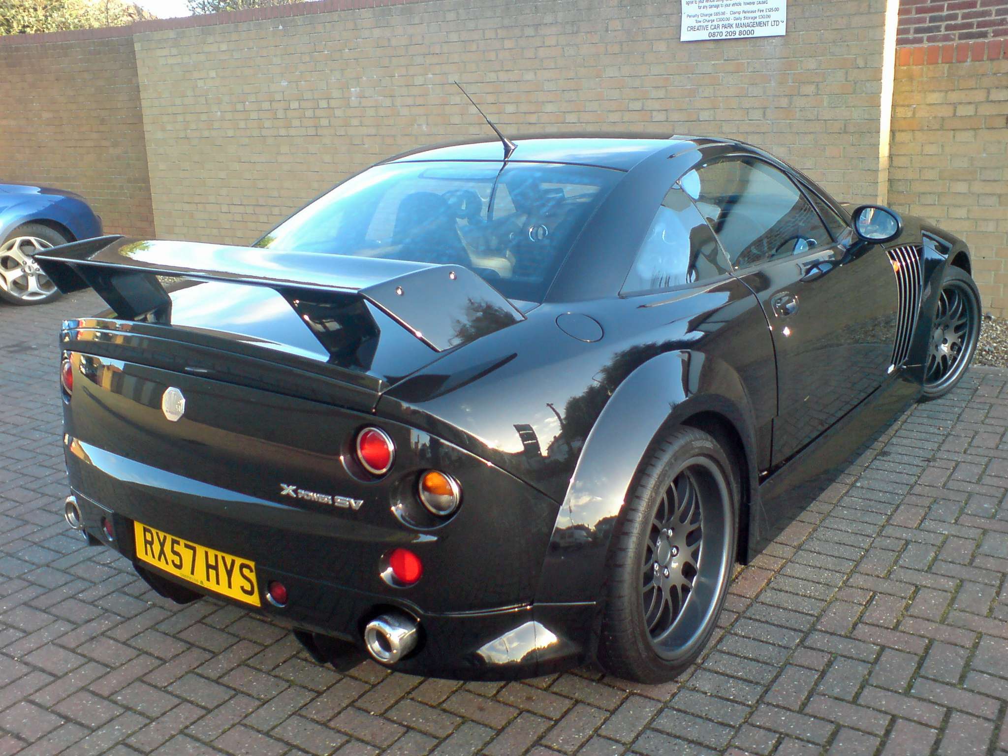 Rear view of a black MG XPower SV