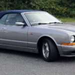 Silver first-generation Bentley Azure front three-quarter with roof raised