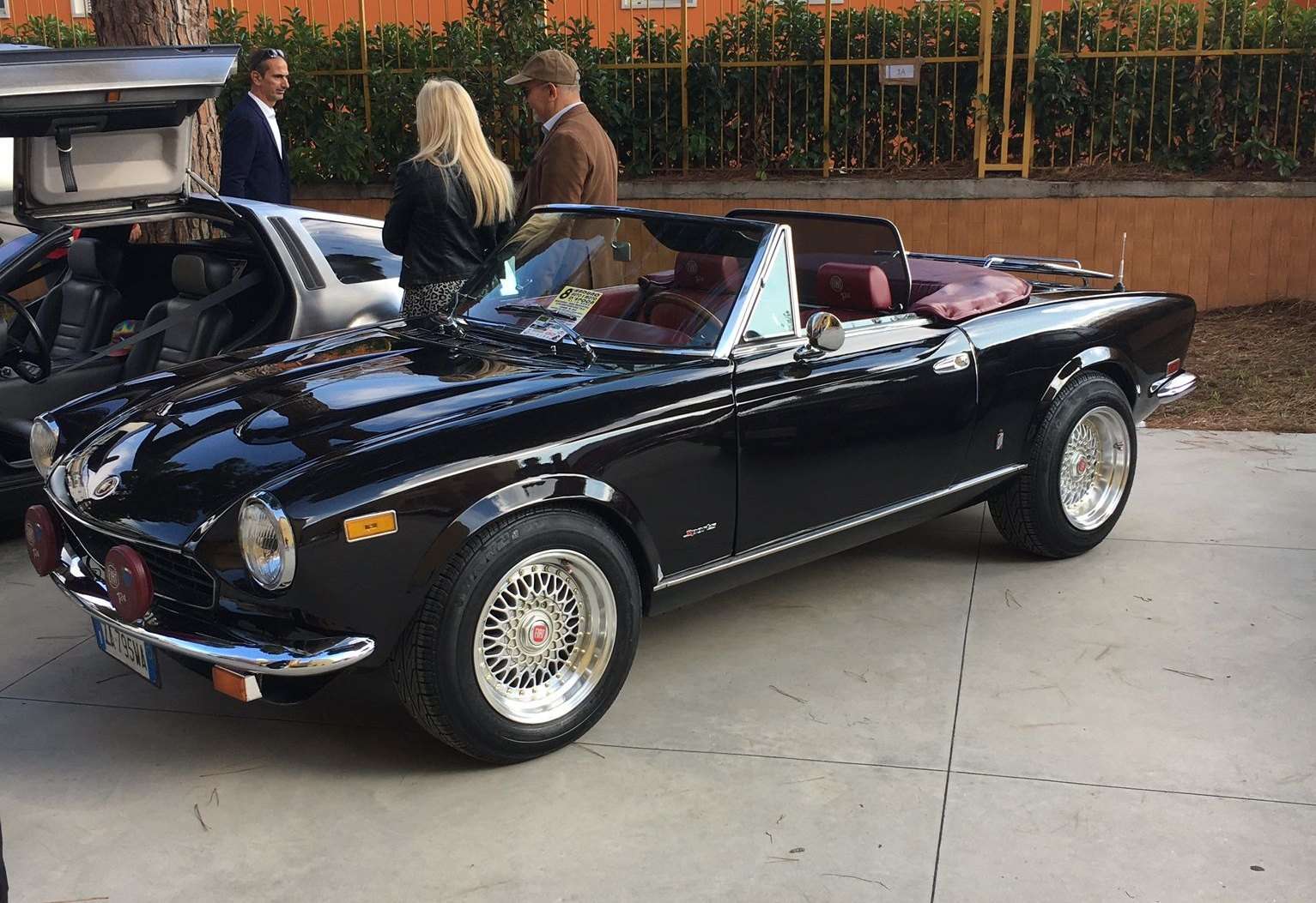 Black Fiat 124 Sport Spider seen from the rear