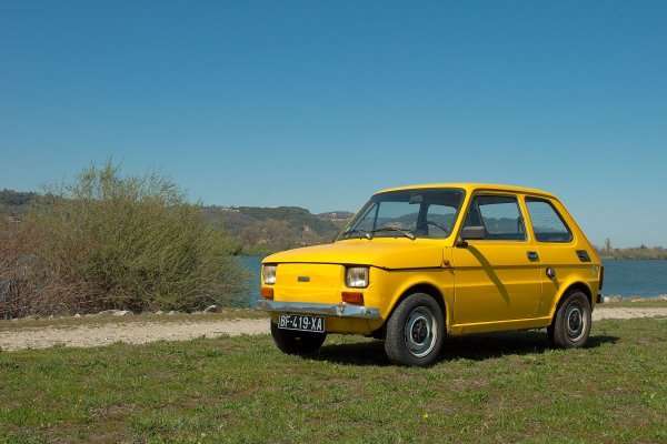 Yellow Fiat 126 at a classic-car gathering