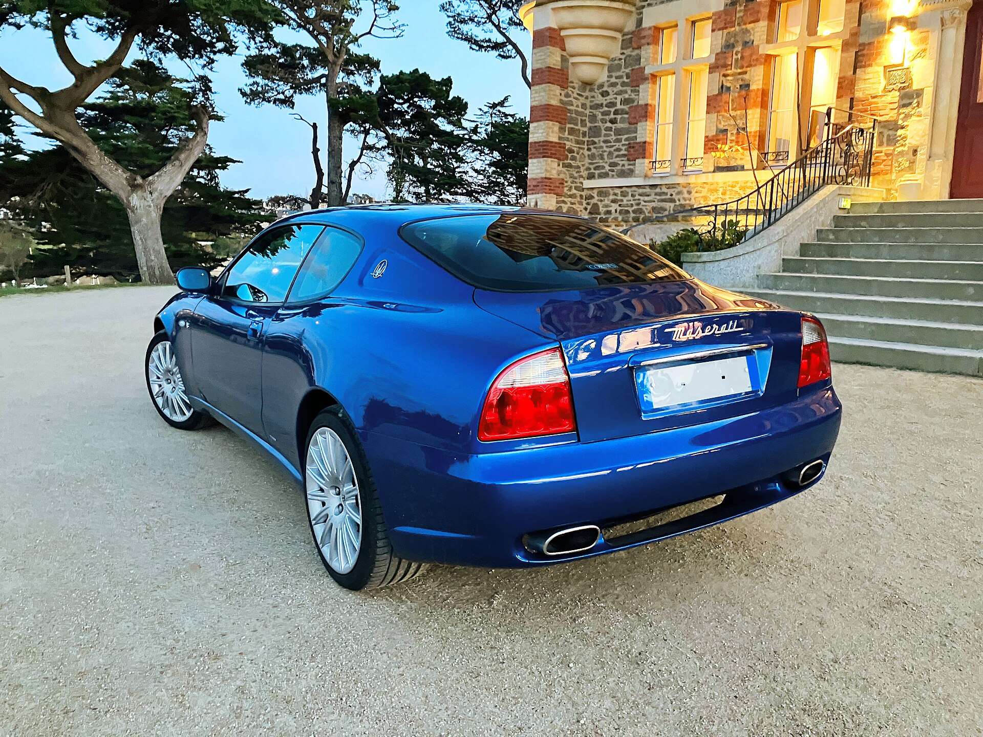 Blue Maserati Coupe 4200 GT from the rear three-quarter