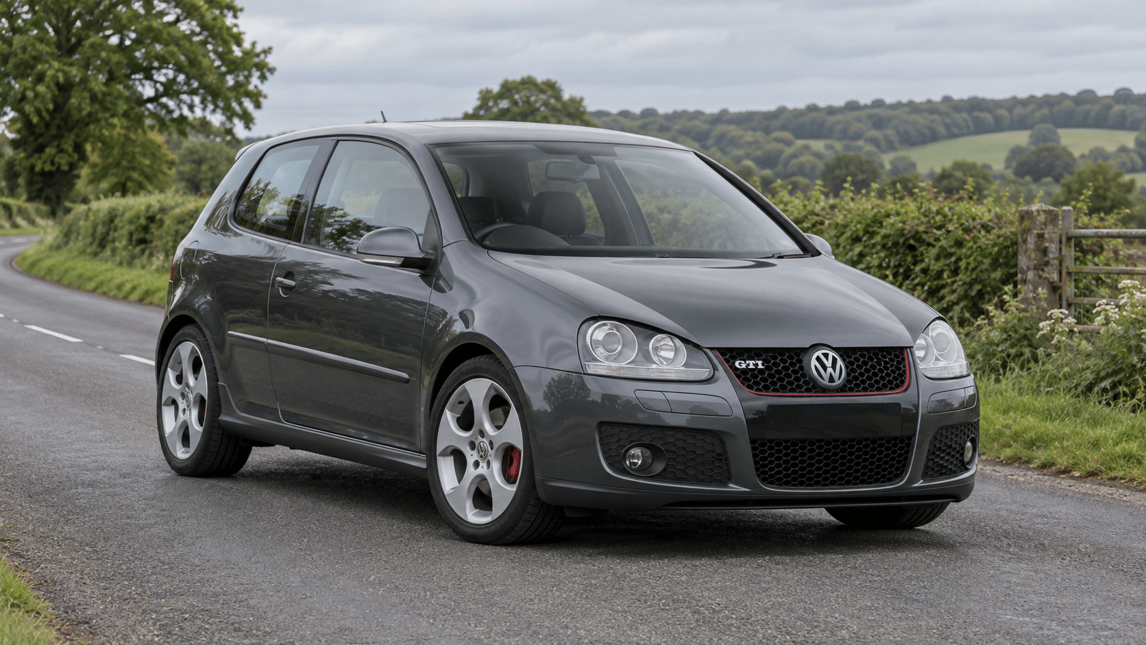 Dark grey Volkswagen Golf GTI Mk5 on a British country road