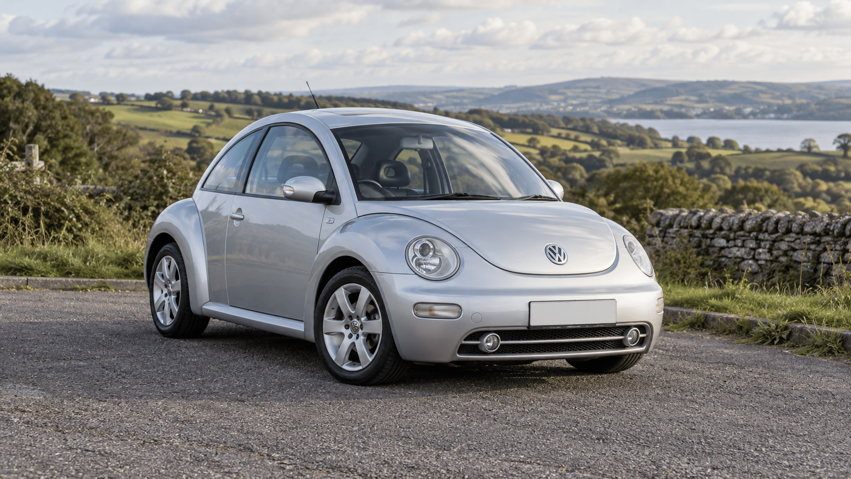 Reflex silver Volkswagen New Beetle 1.8T in the British countryside — illustrative artwork