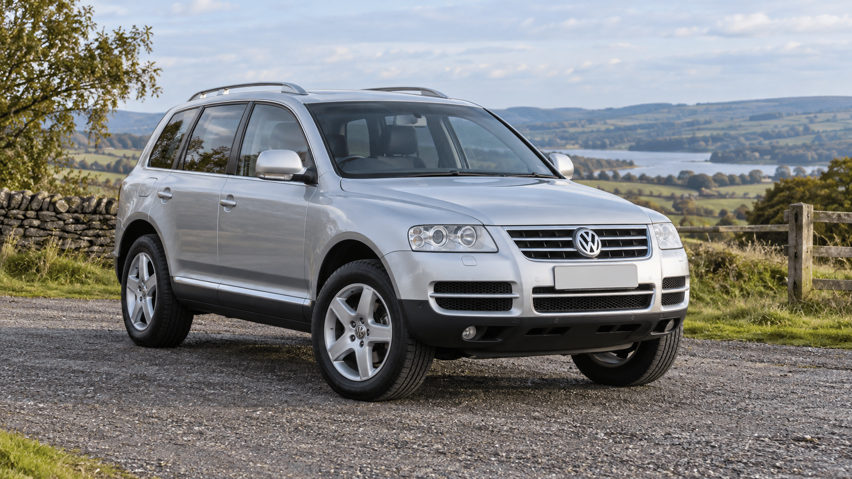 Silver Volkswagen Touareg Mk1 (7L) on a British country road — illustrative artwork